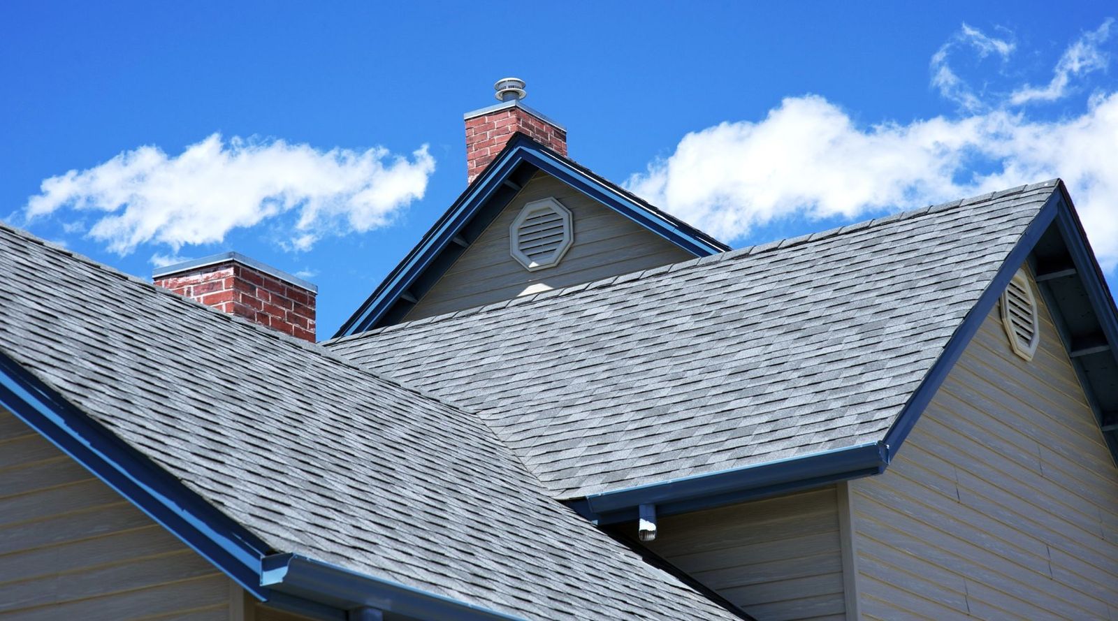 Roof featuring gray shingles and blue trim, showcasing the work of GNU Construction.